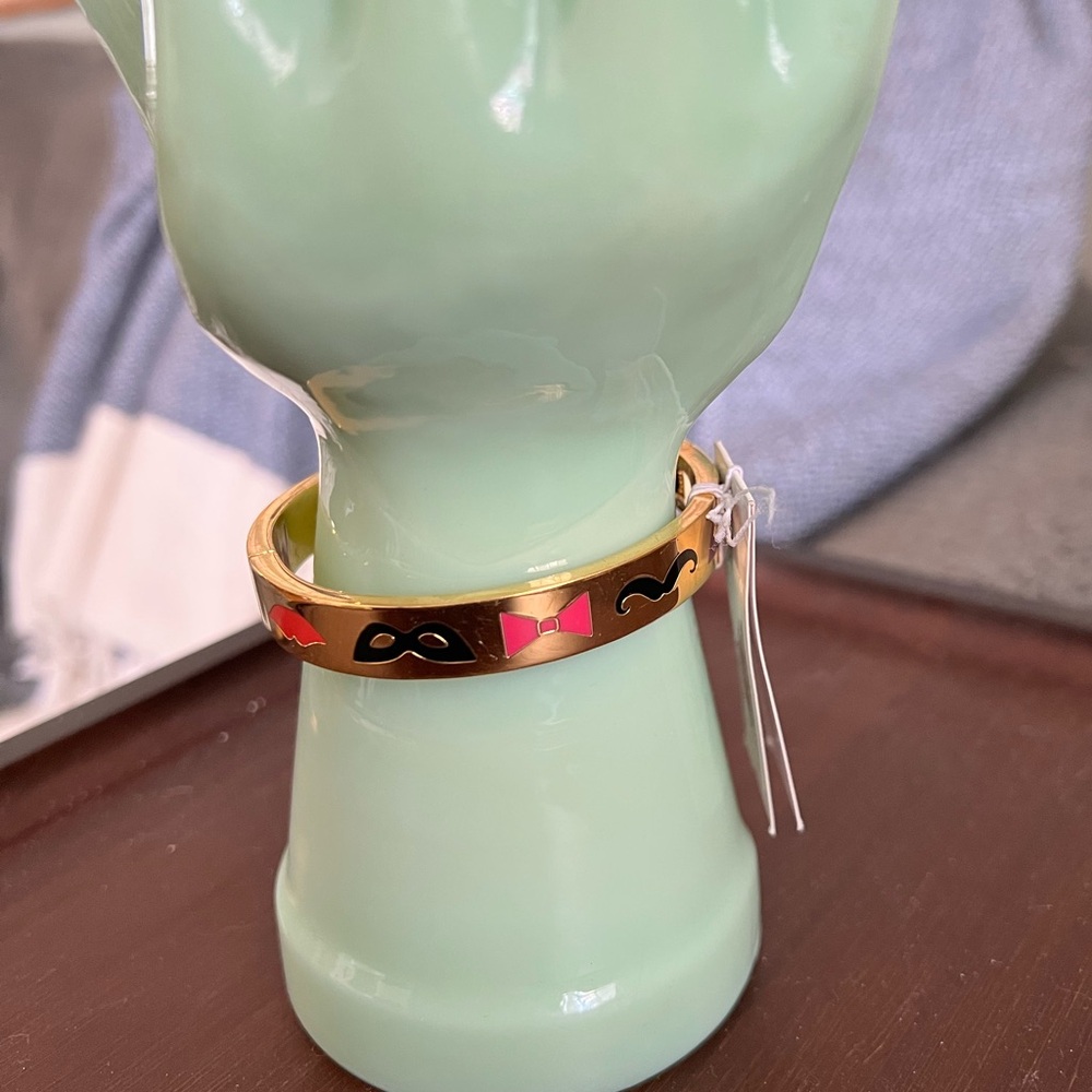 Kate Spade New York gold tone hinged bangle. “Blessing in Disguise” inside.